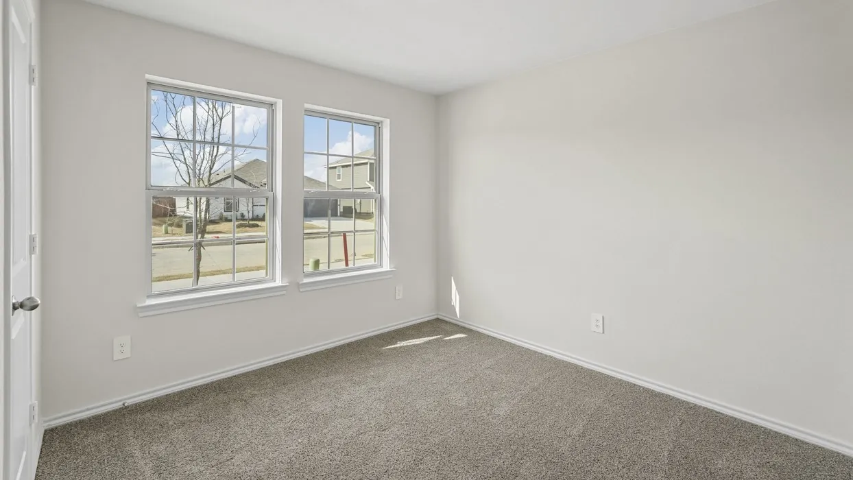 Bright interior room featuring neutral gray carpeting and light-colored walls