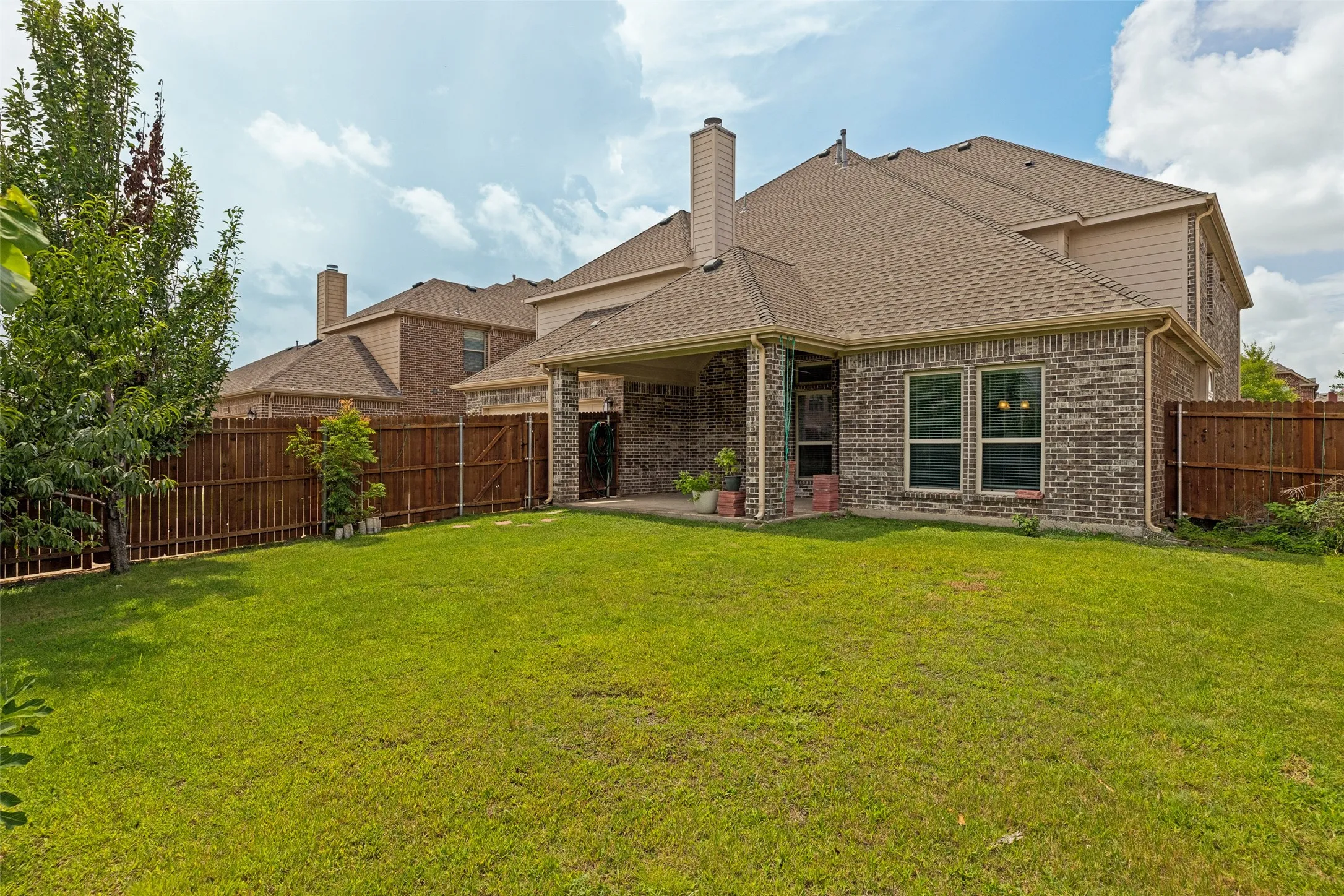 Expansive backyard featuring a lush lawn and fenced yard.