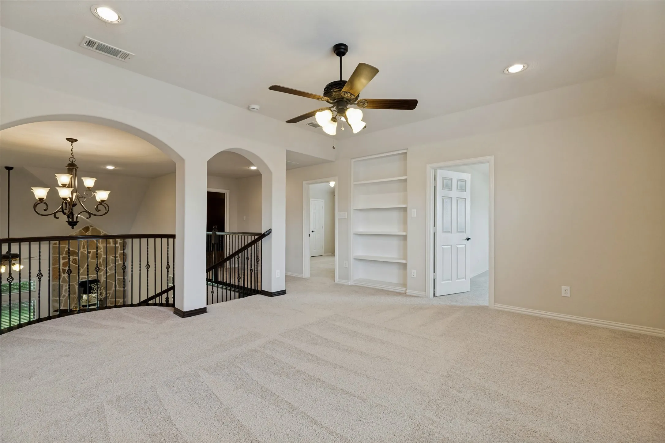 View 2: Game Room Carpeted open area featuring a ceiling fan with integrated lighting, recessed ceiling lights, and built-in shelving