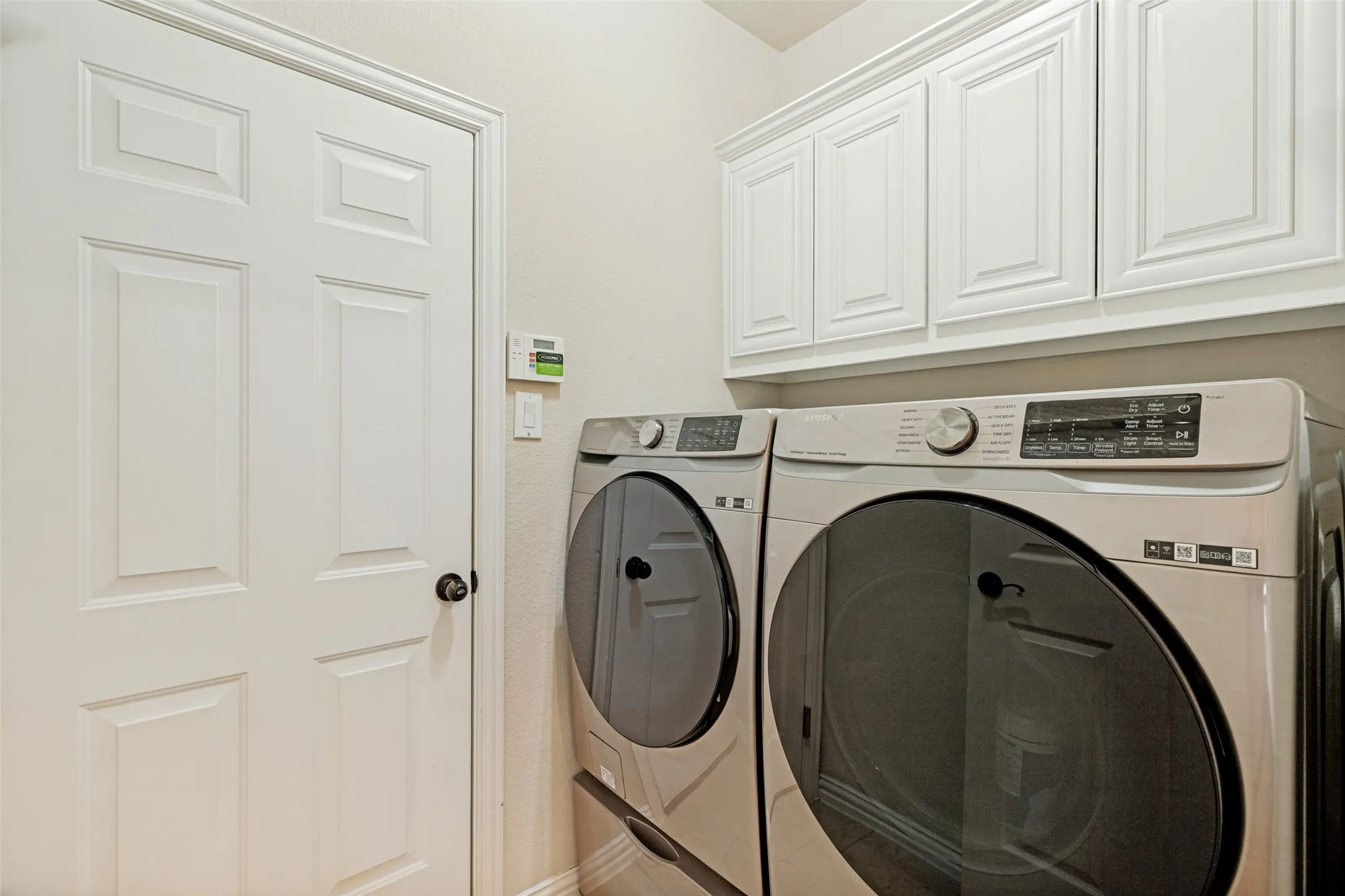 Laundry Space with Cabinetry and overhead storage space
