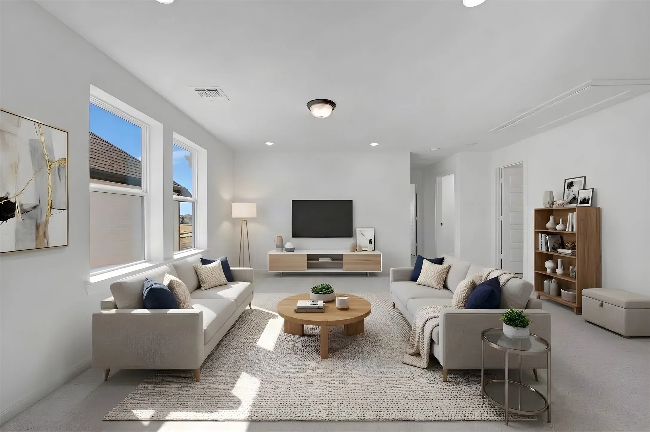 Spacious interior with neutral wall tones, recessed lighting, and dual windows