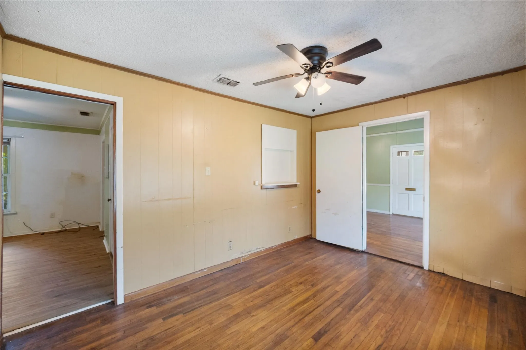 Hardwood floors and natural light enhance one of three living areas within the versatile 1,575-square-foot floor plan.