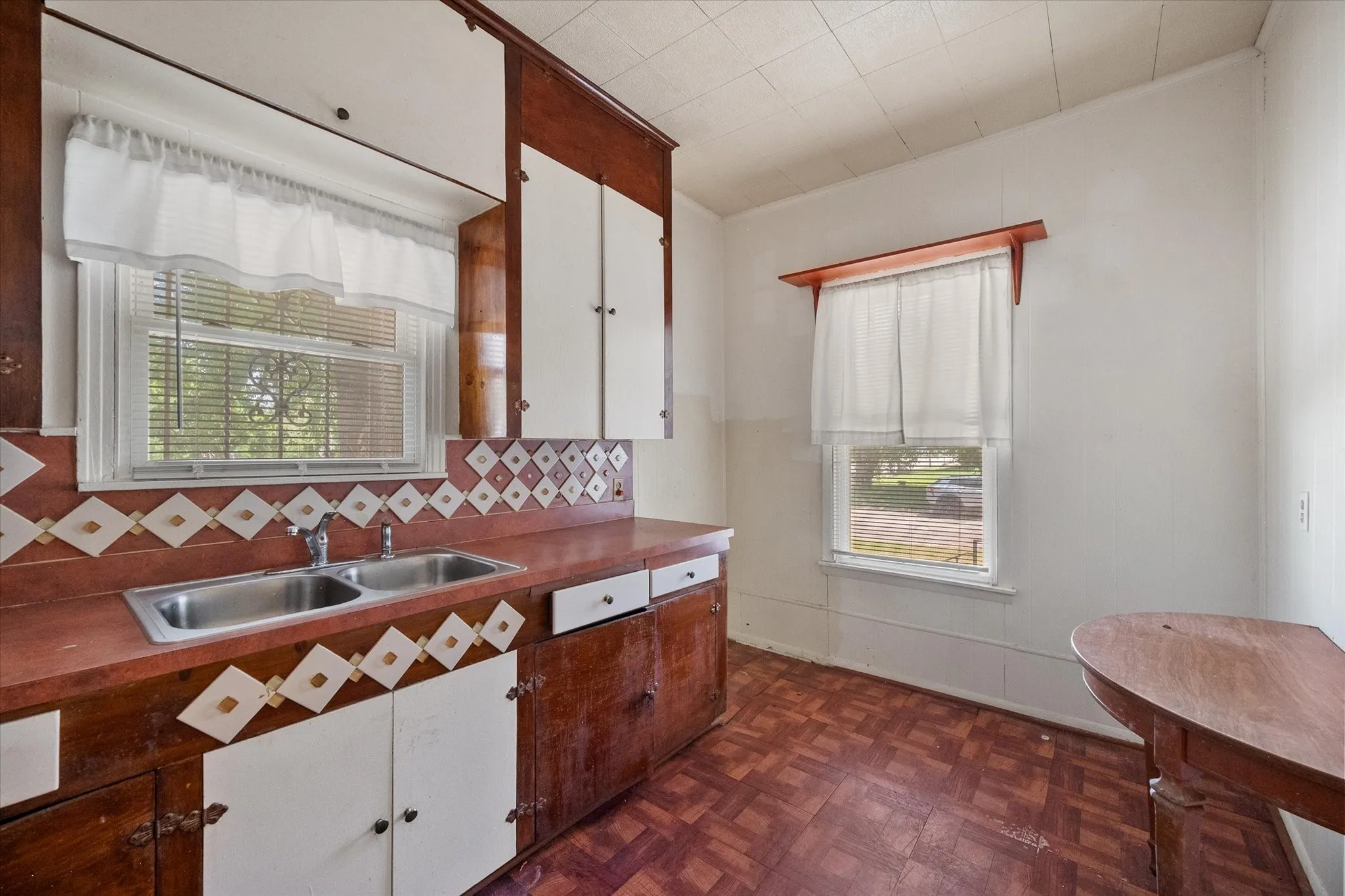 Natural light and space for a small table support the kitchen’s convenient eat-in layout.