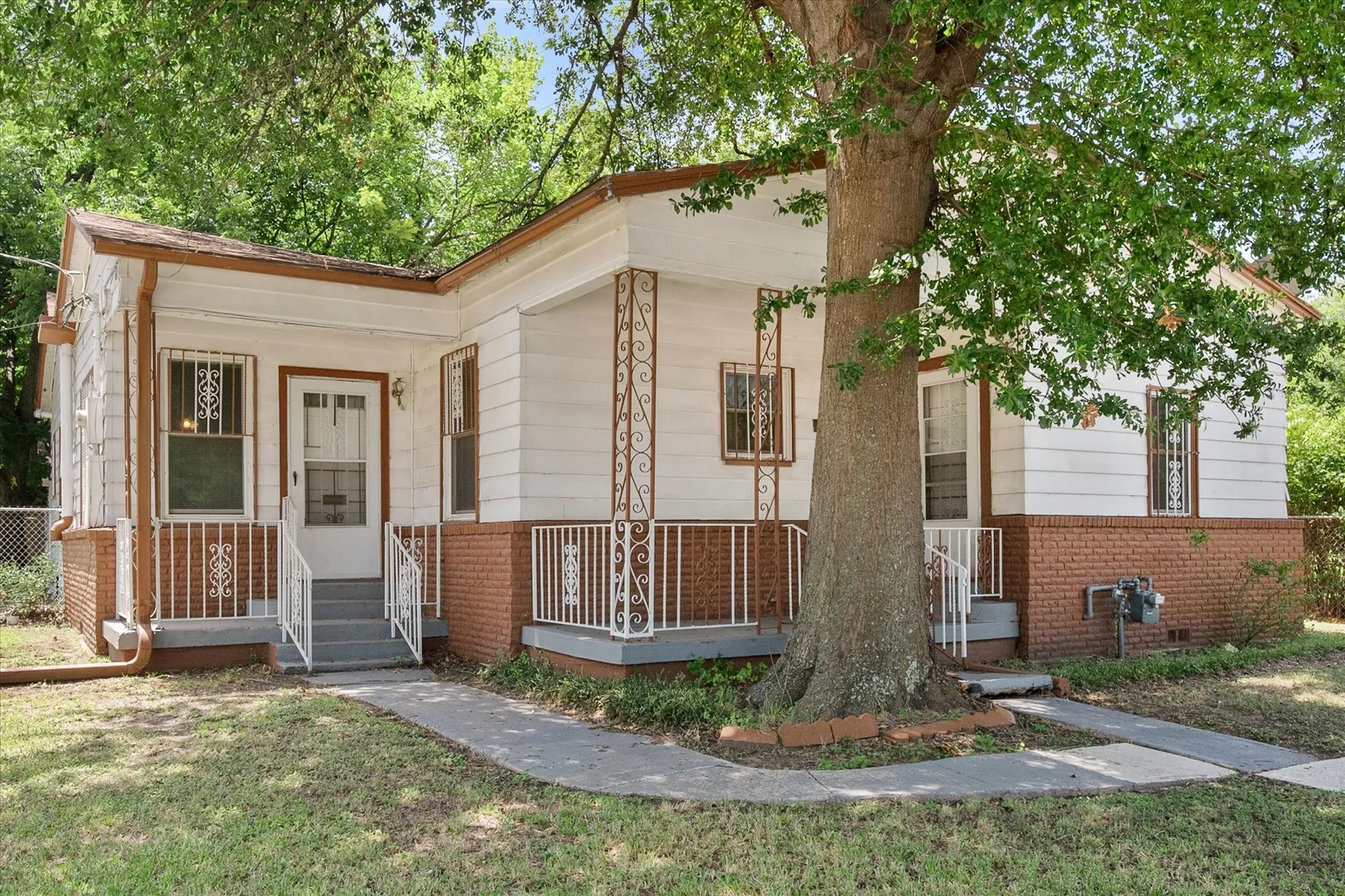 Multiple covered entry areas complement the home’s versatile layout and distinctive 1930 exterior character.