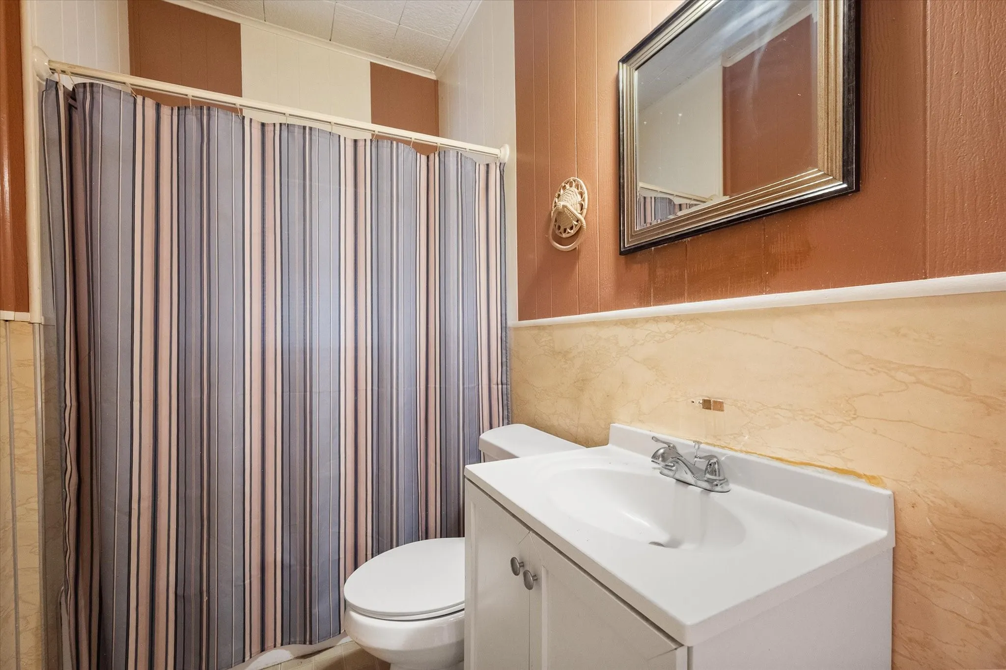 One of two full bathrooms includes a tub-shower combination, vanity, and practical storage.