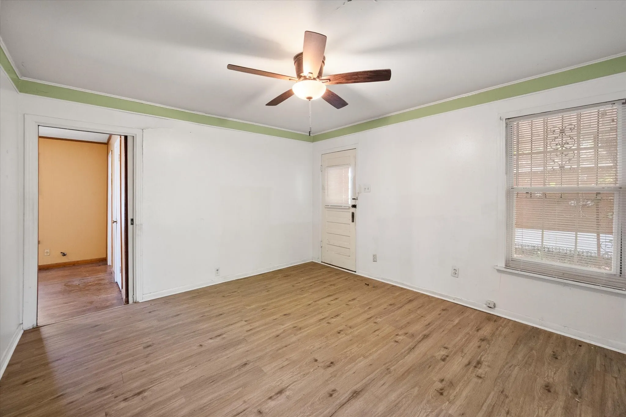 This bright room offers durable flooring, a ceiling fan, a closet, and a separate exterior entrance.