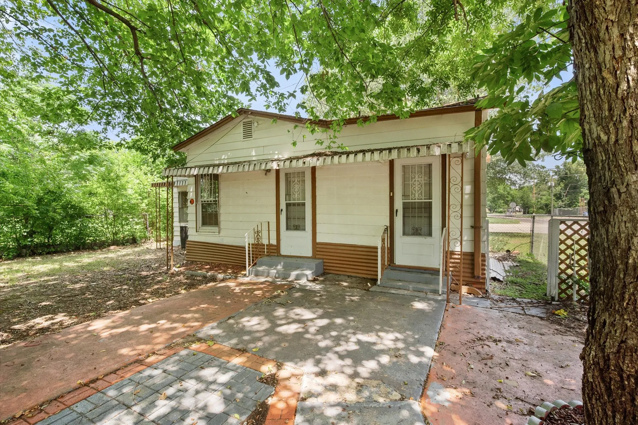 Multiple rear entrances support a versatile floor plan currently configured with two bedrooms, two bathrooms, and three living areas.