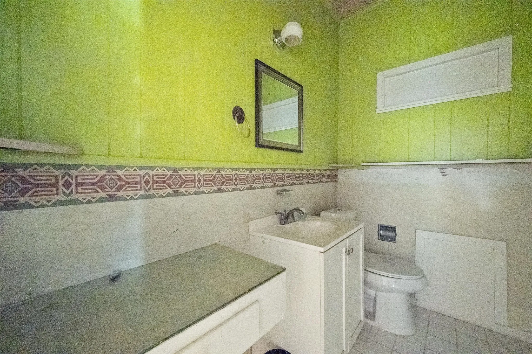A second full bathroom supports the home’s current two-bedroom, two-bath configuration and former duplex layout.