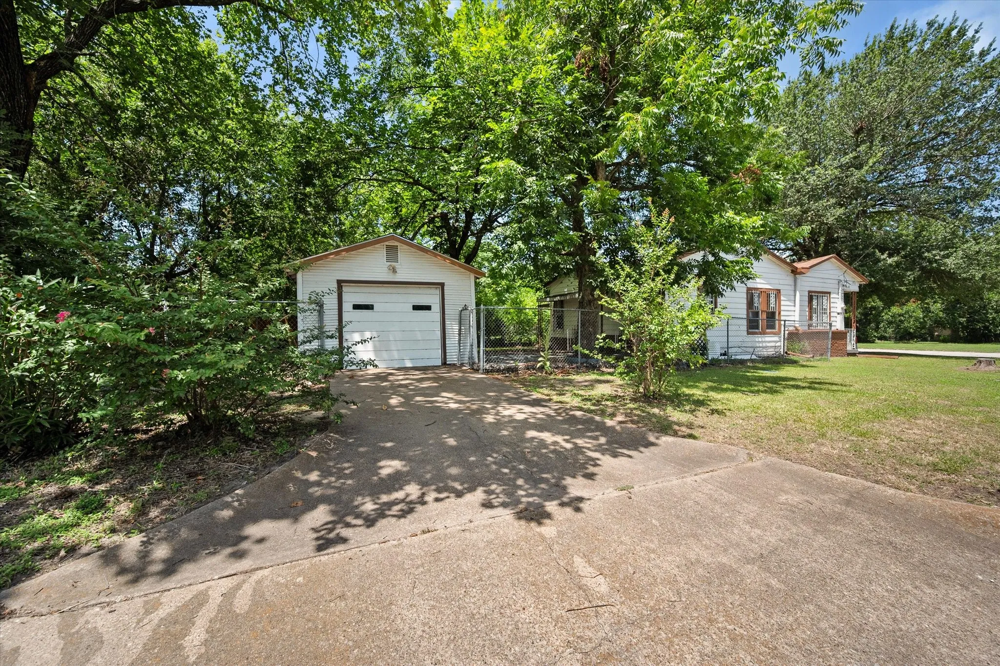 Detached single car garage has additional room for a workshop.