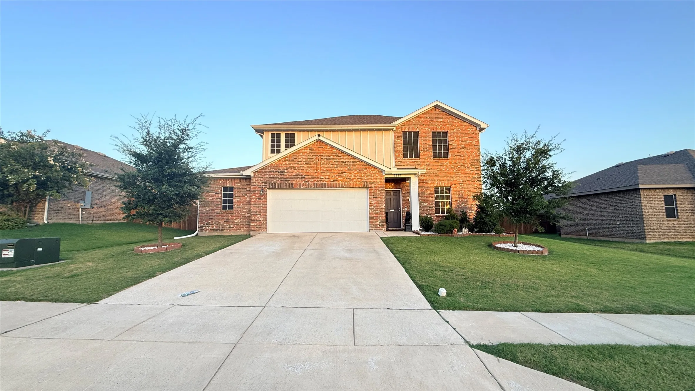 Traditional brick exterior with an attached garage and concrete driveway