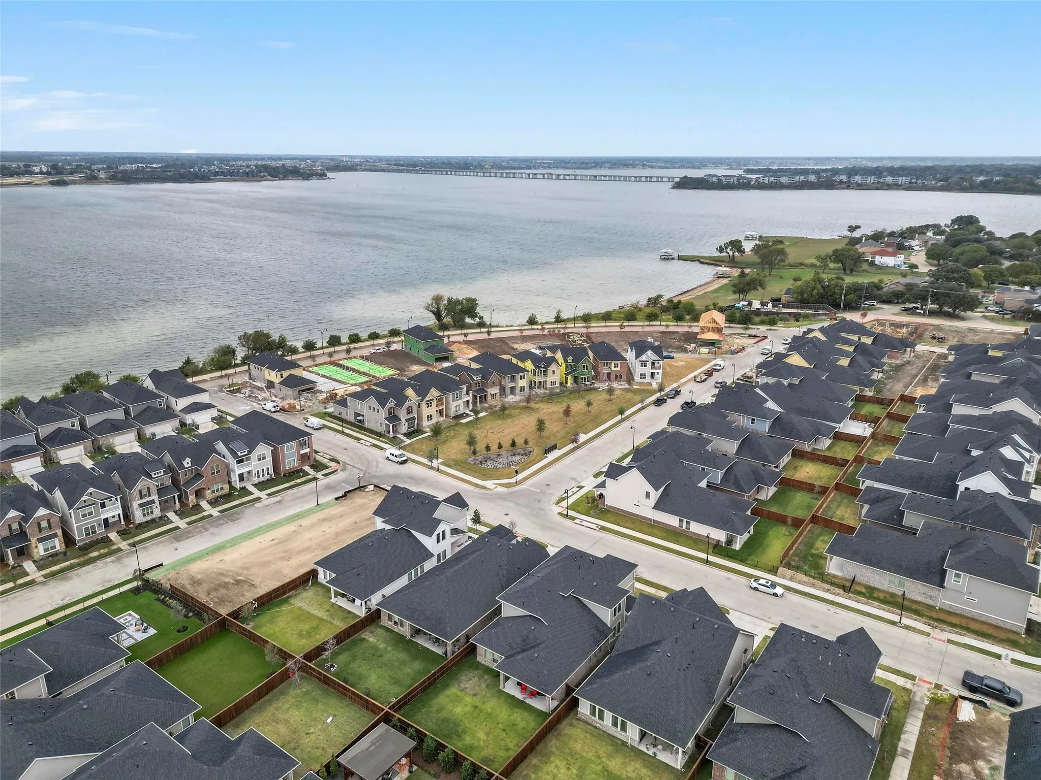 Aerial view of residential area with a nearby beautiful lake  and a notable bridge