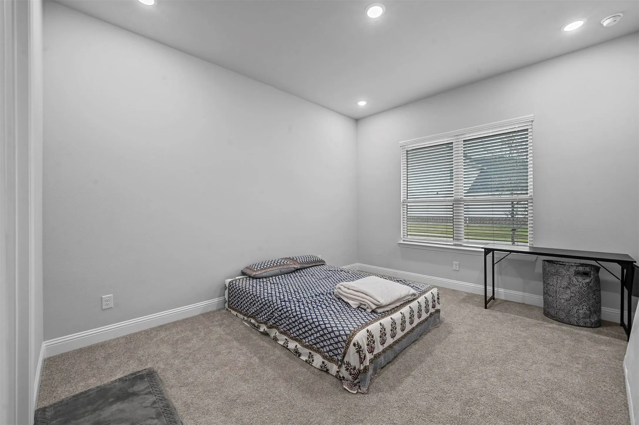 Carpeted bedroom with baseboards and recessed lighting