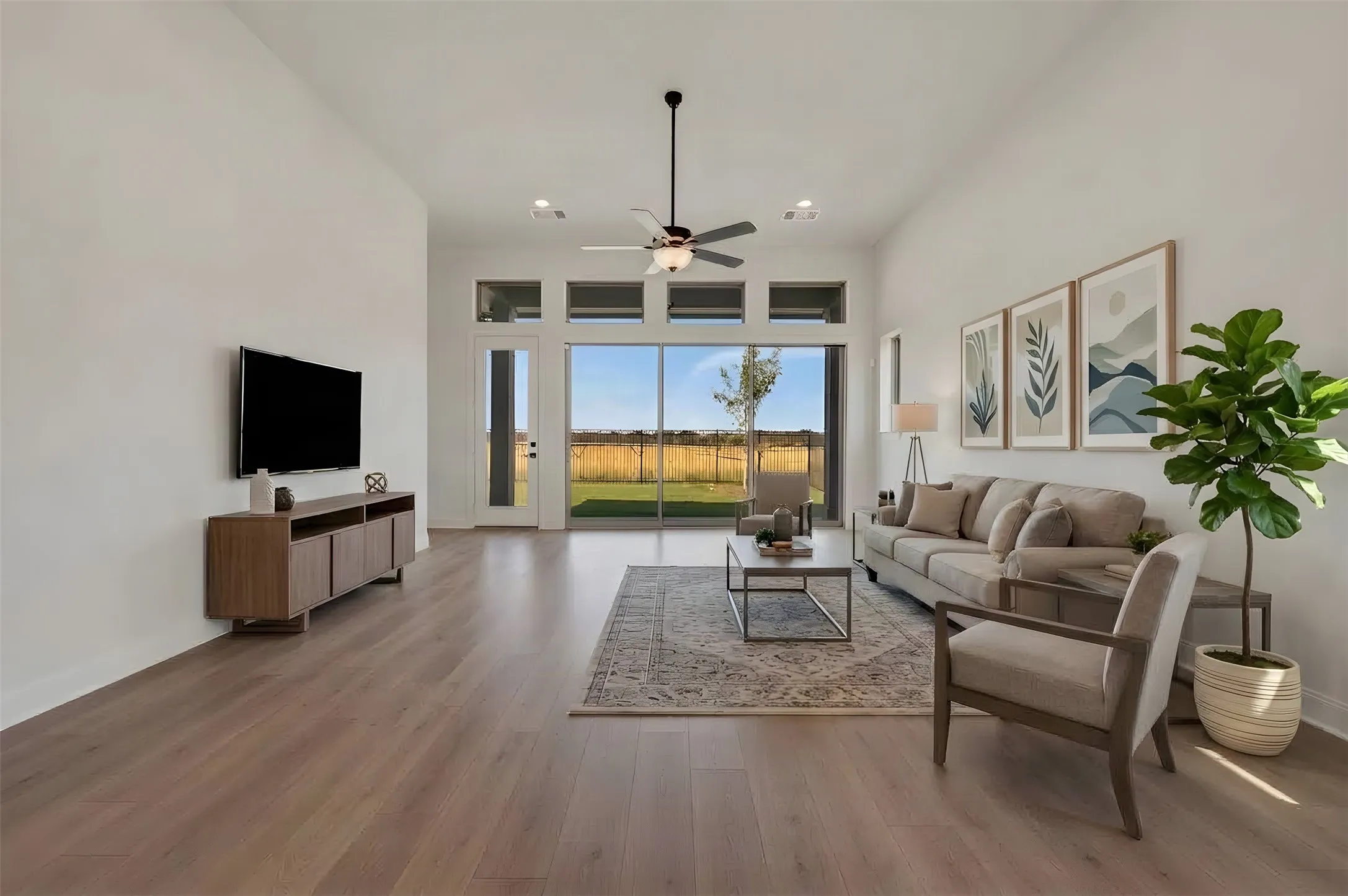 Soaring ceilings, wood-finish flooring, and recessed lighting create a bright interior