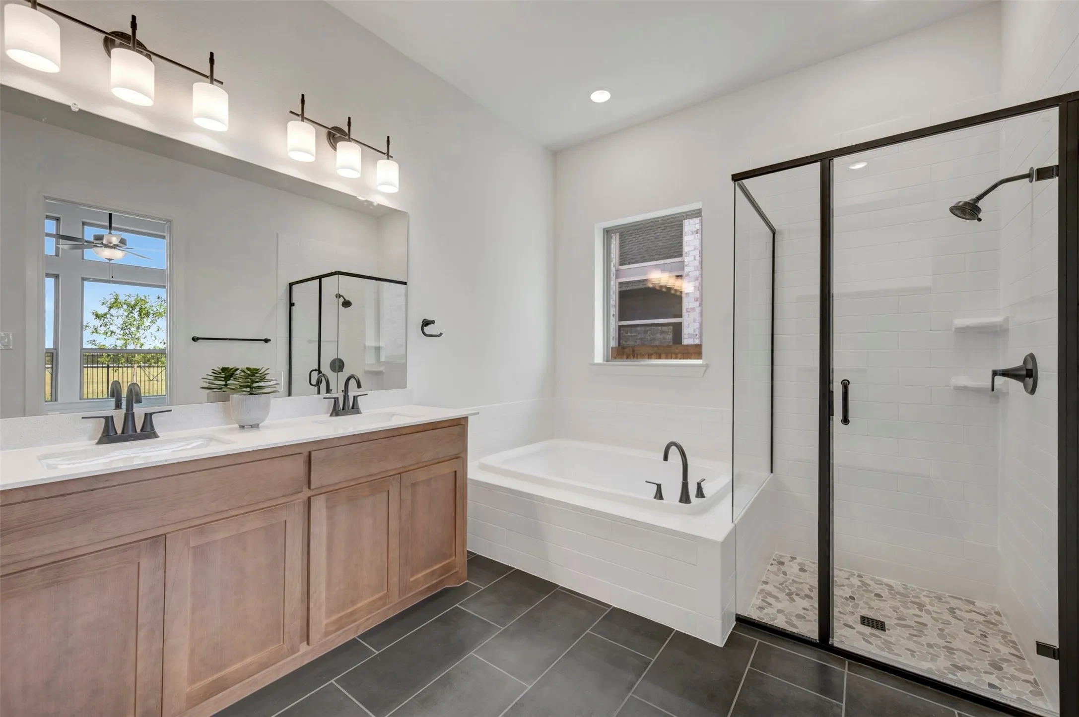 Dual vanity with white countertop, undermount sinks, and matte black fixtures