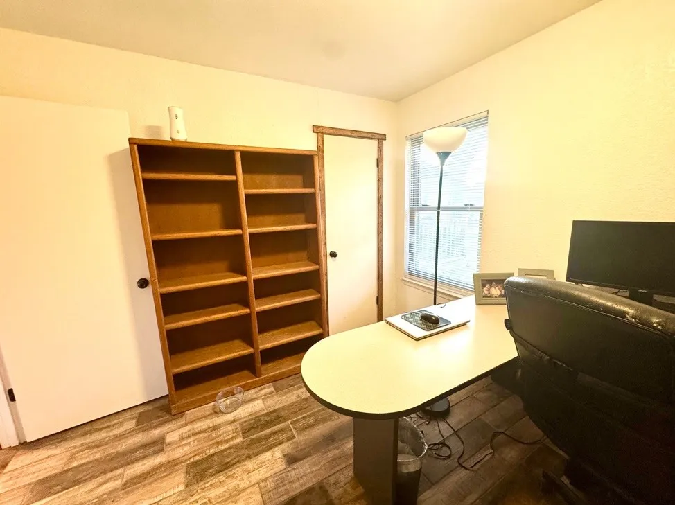 Neutral wall tones with wood-finish flooring