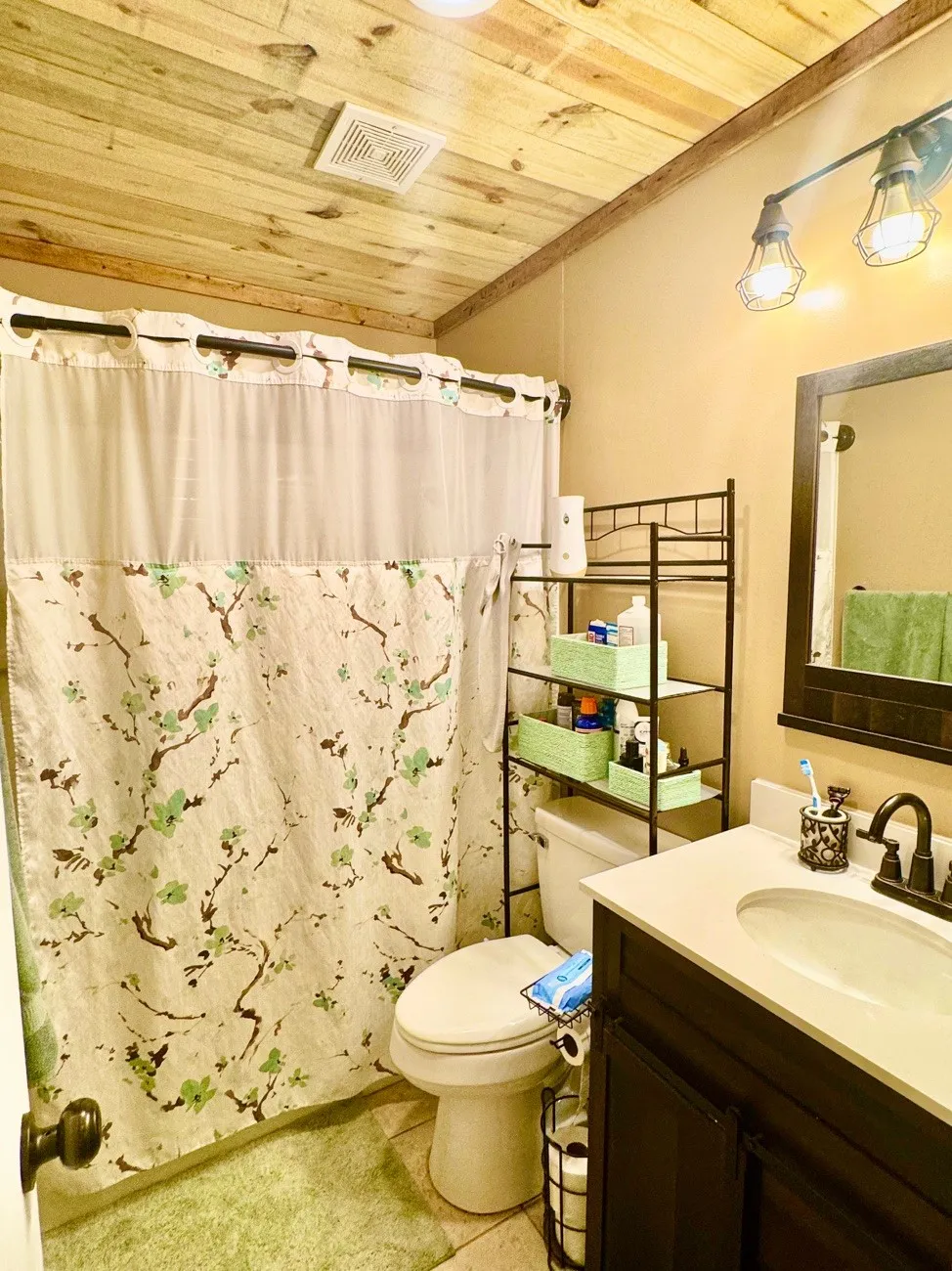 Bathroom featuring a wood-finish plank ceiling, tile flooring, and a vanity with a white countertop and dark wood-finish cabinetry