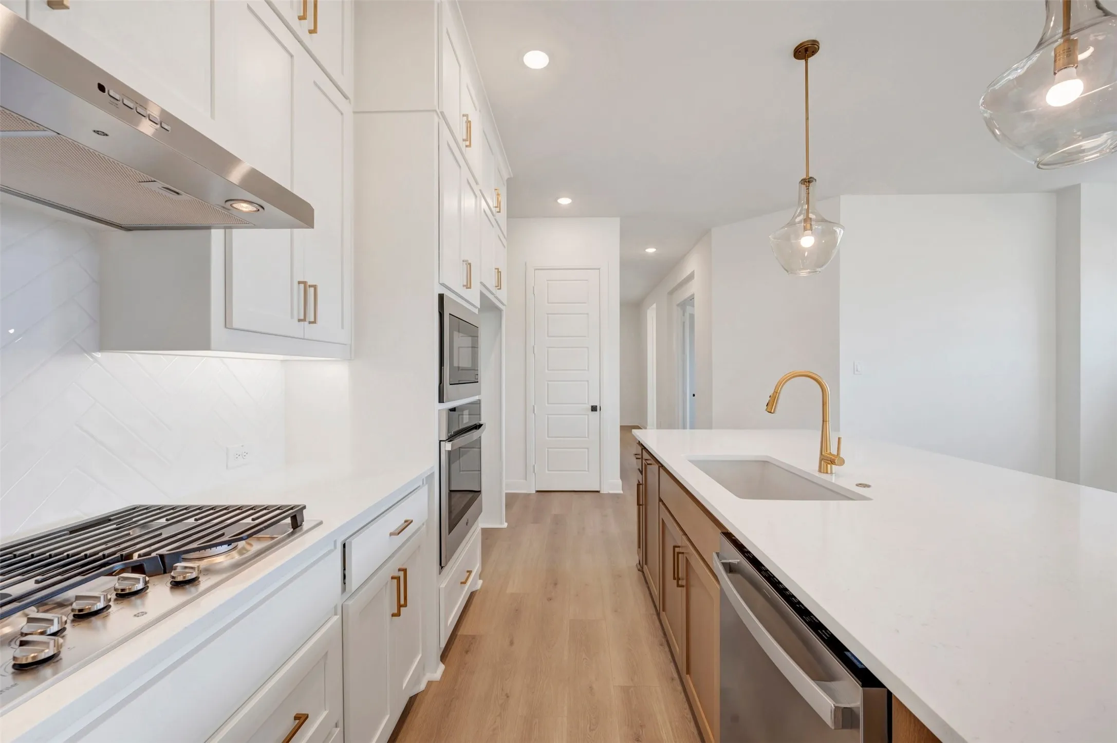 White shaker cabinetry with gold-tone hardware