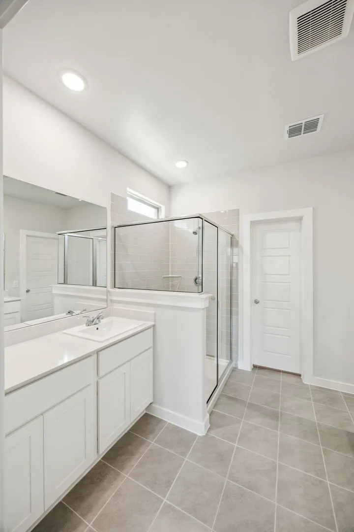 Primary Bathroom in the Masters home plan by Trophy Signature Homes – REPRESENTATIVE PHOTO