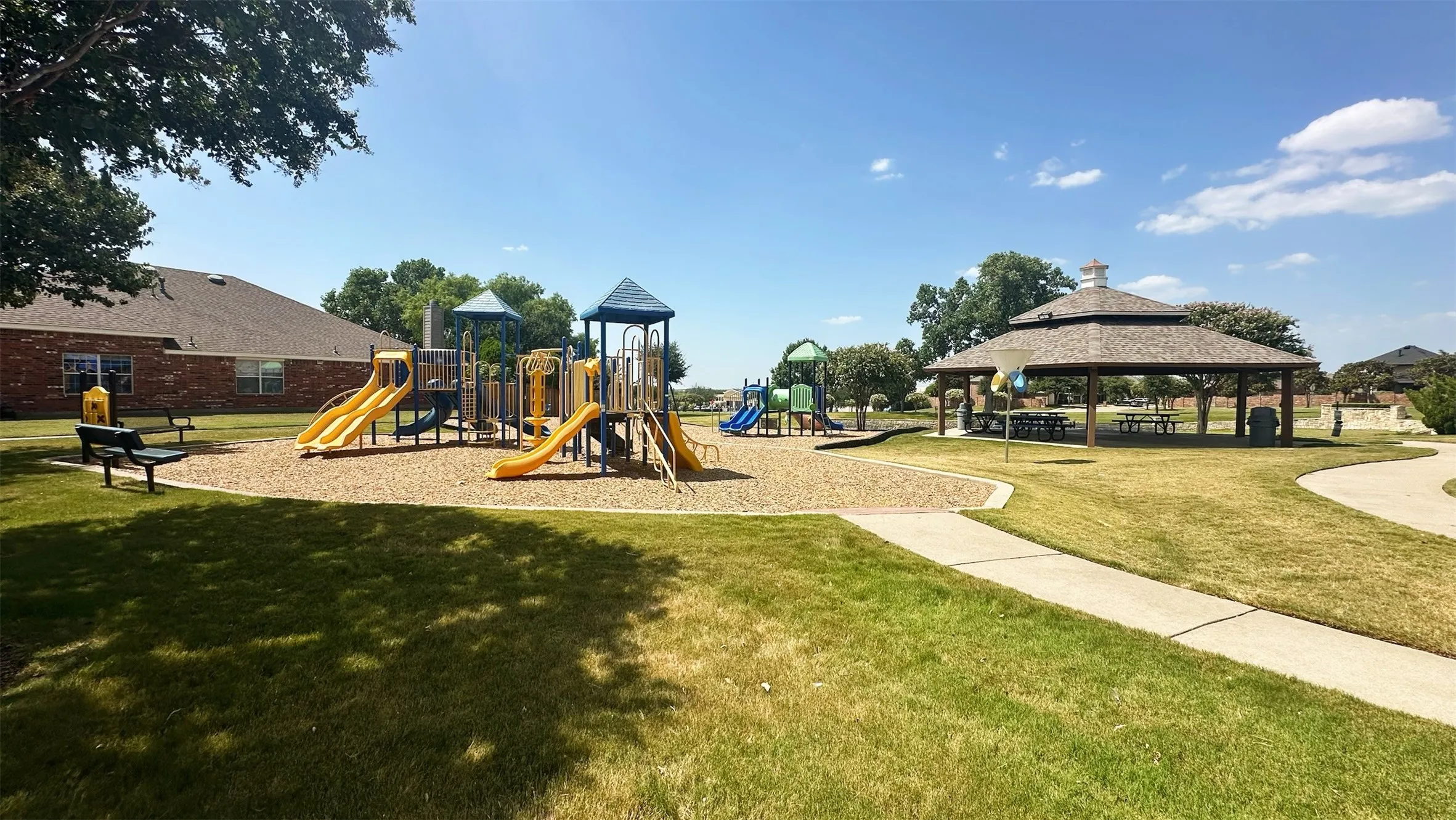 Community playground and park space at Carter Ranch in Celina, Texas. Located within walking distance of 414 Dartmoor Dr, this neighborhood park includes modern play equipment, open green space, and shaded seating areas for Carter Ranch residents.