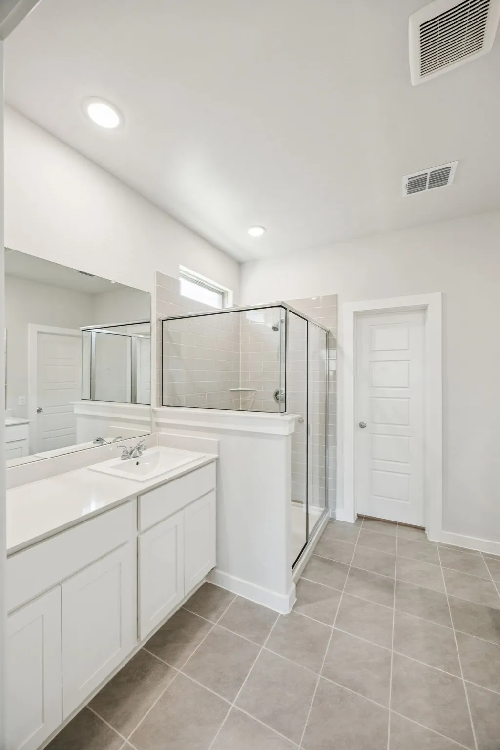 Primary Bathroom in the Masters home plan by Trophy Signature Homes – REPRESENTATIVE PHOTO