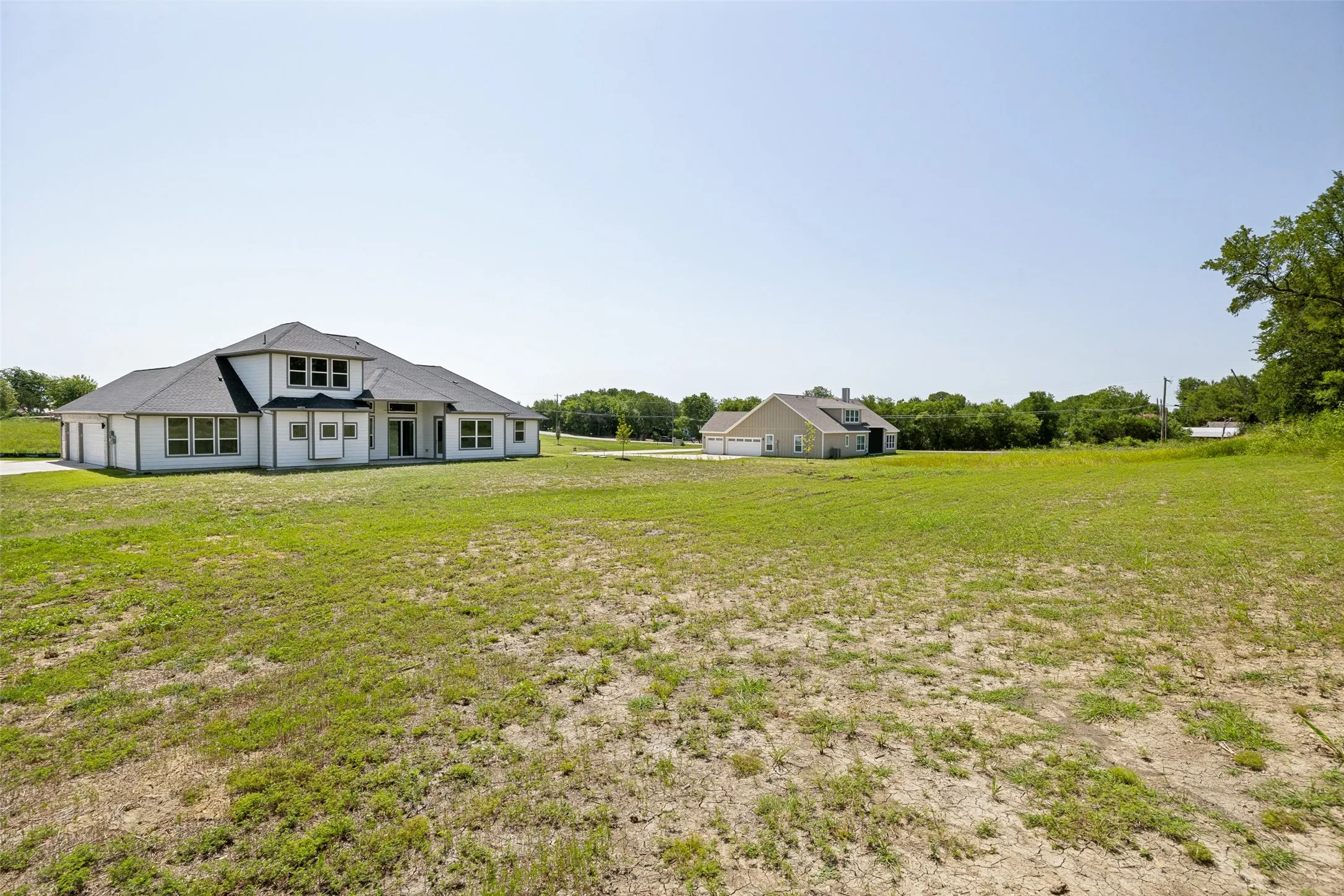Expansive green space with distant properties
