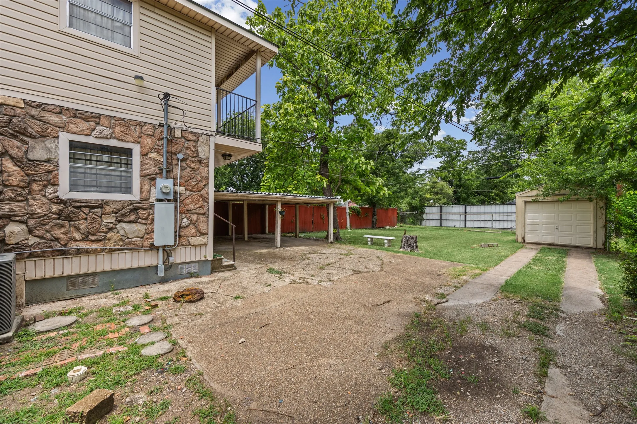 Side of house with view of the two car carport and the one car garage