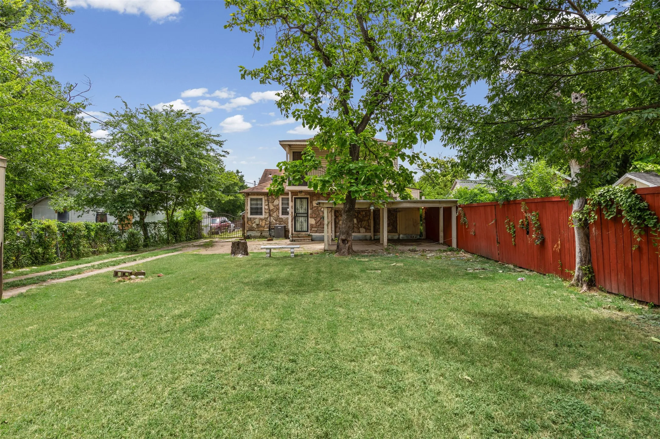Large Fenced Backyard with Iron Gate