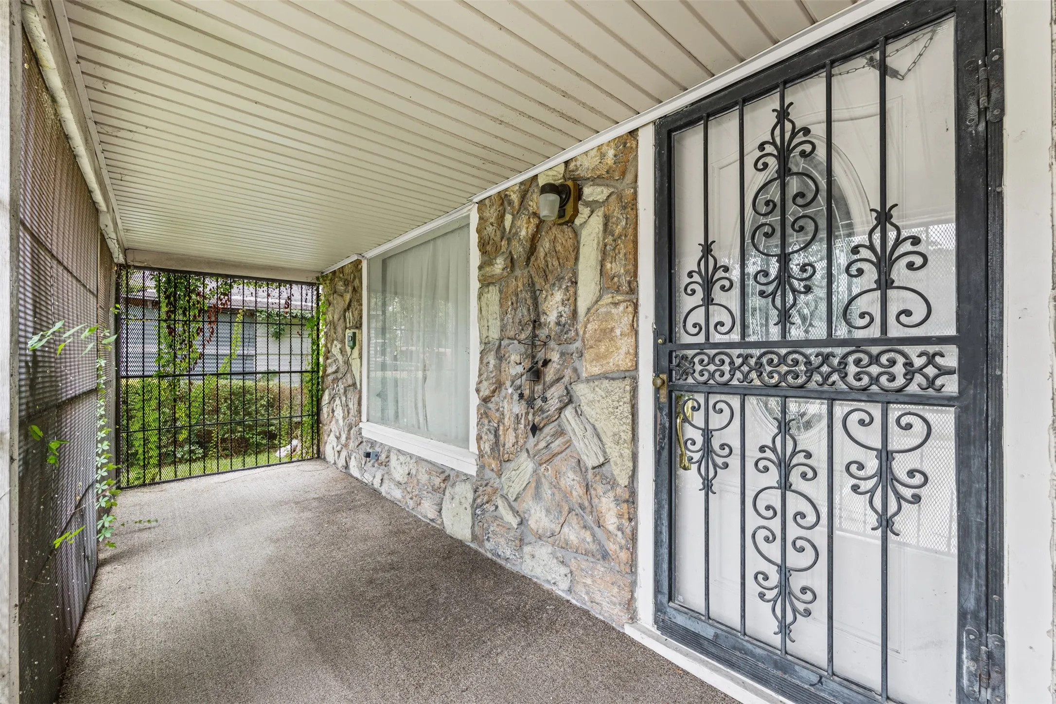 Screened front porch with security bars.
