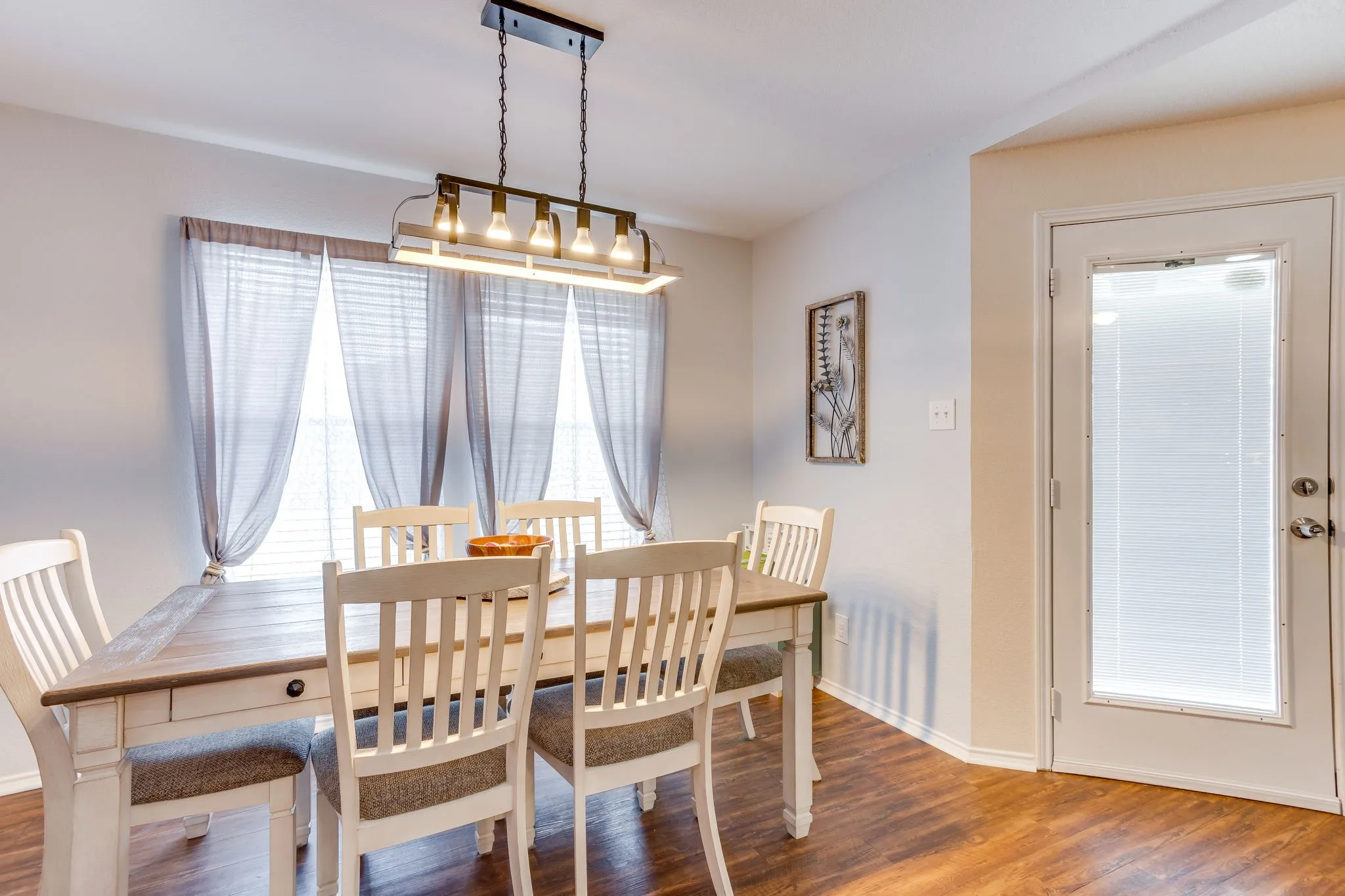 Dining area featuring a glass-paneled door providing additional natural light convenient to the back yard.