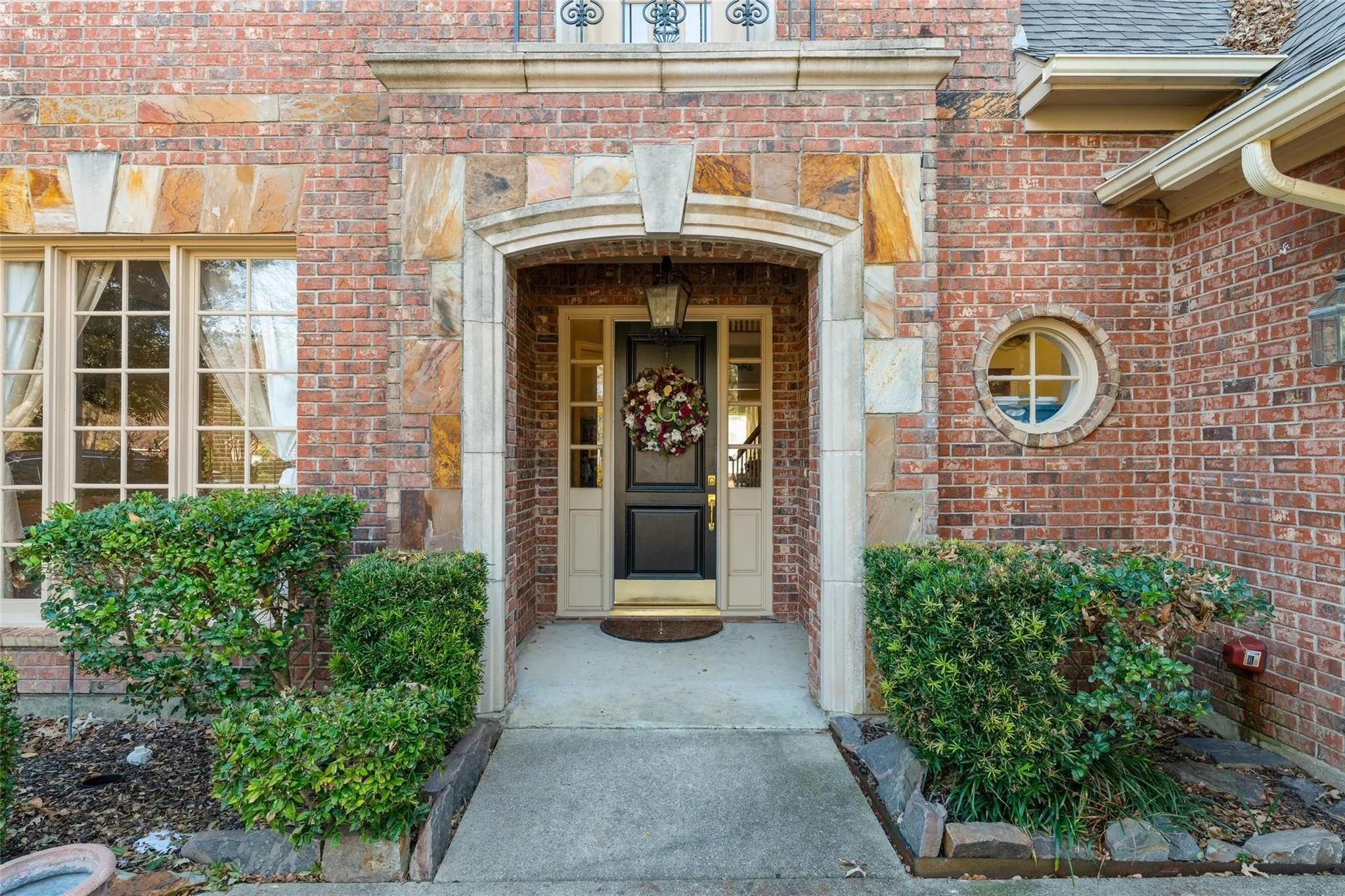 Brick exterior featuring stone accents and a prominent entryway