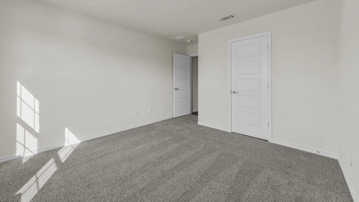 Spacious room featuring neutral carpeting and white walls