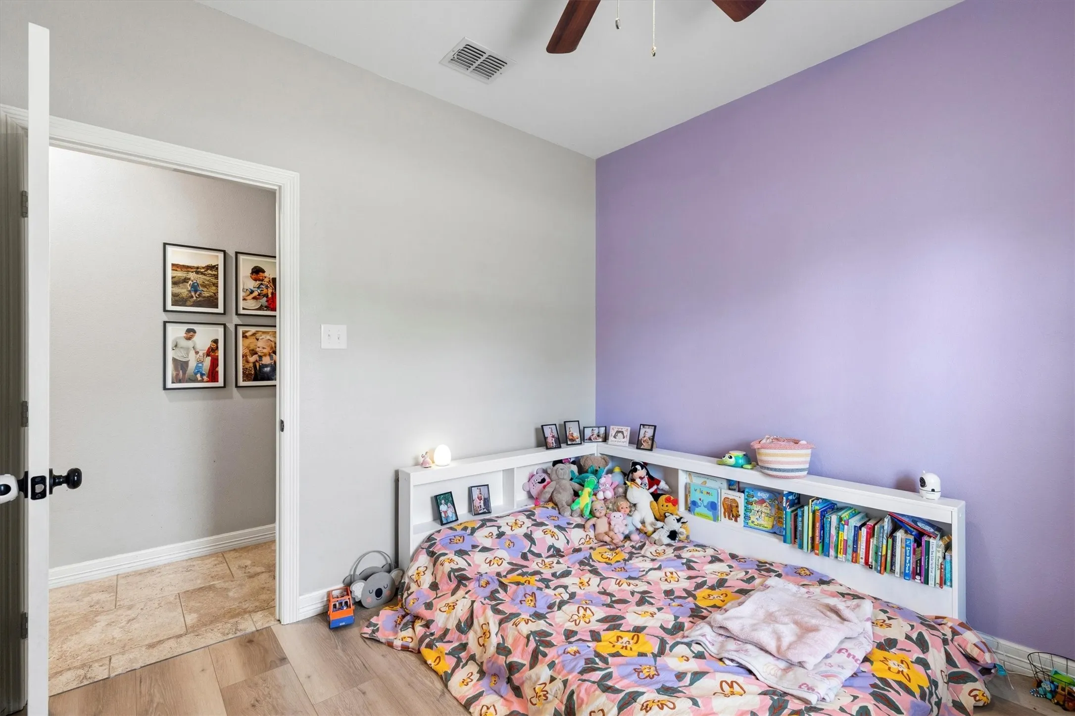 Interior room featuring wood-finish flooring and light gray walls