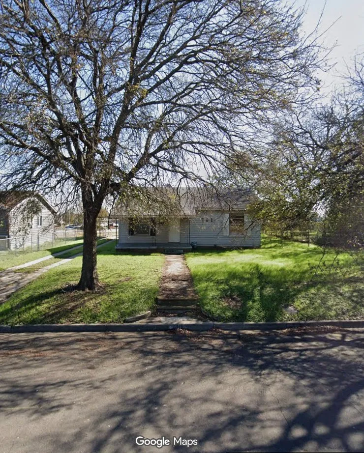 Single-story residence featuring light-colored siding and a covered front entry