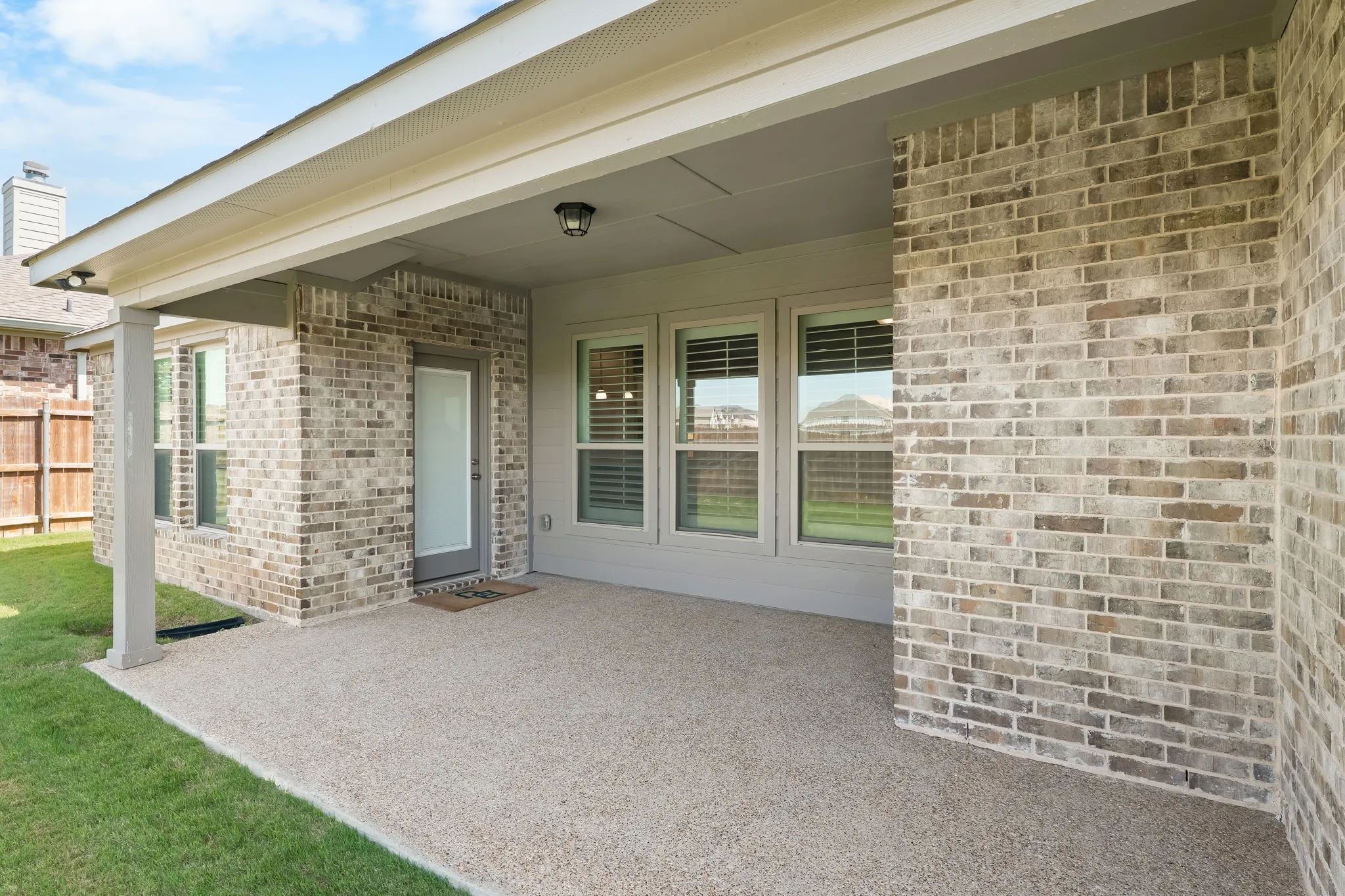 Covered patio with an exposed aggregate concrete surface