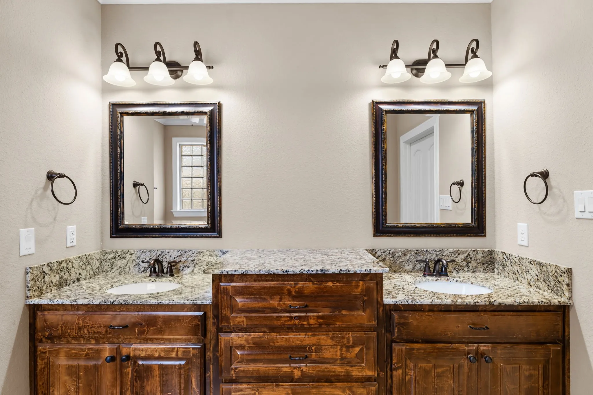 Double vanity featuring granite countertops and undermount sinks