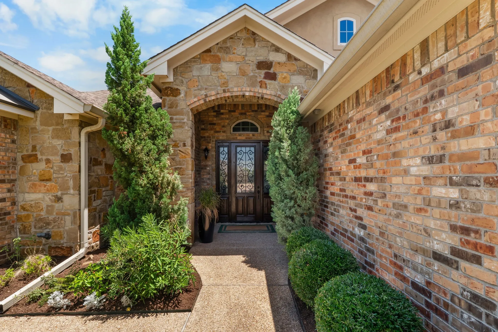 Stone and brick facade with an arched entryway