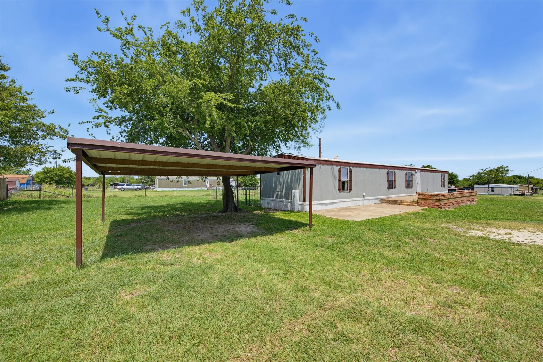 Front of property with carport and concrete front patio