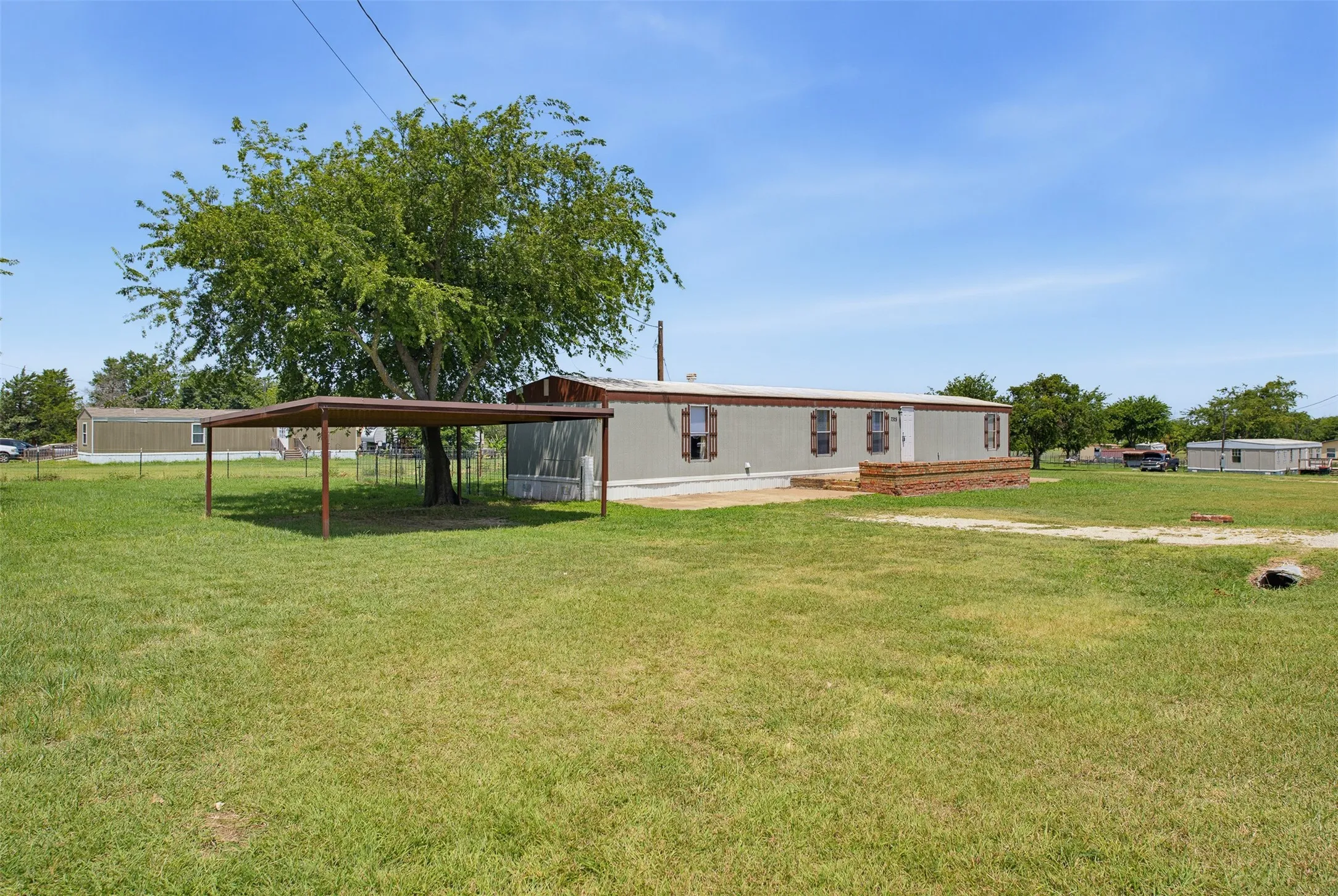 Front of property with carport and concrete front patio