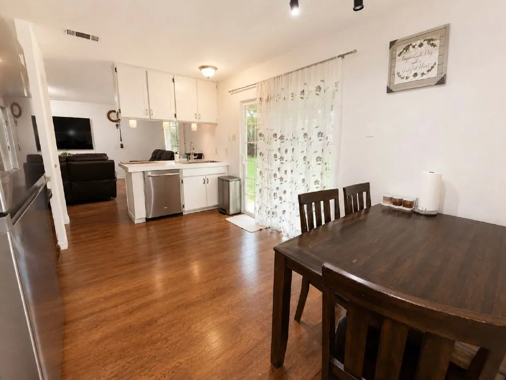Kitchen and dining area featuring wood-finish flooring
