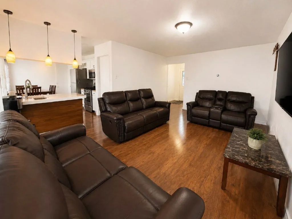 Open-concept living space featuring wood-finish flooring