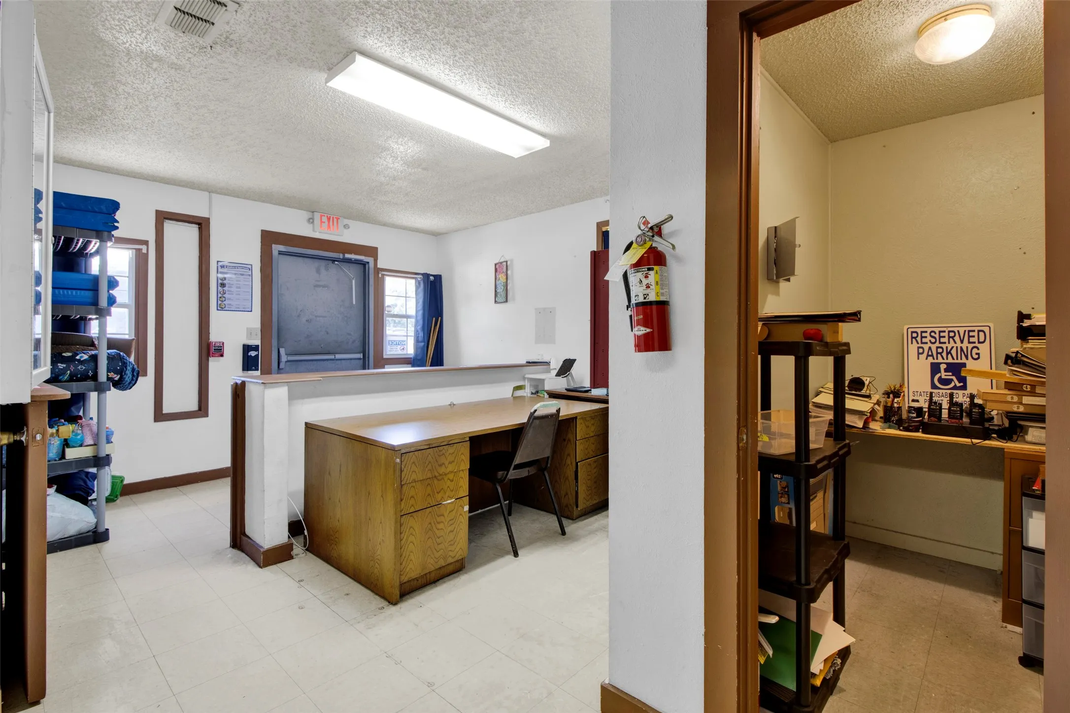 Spacious interior area featuring neutral wall paint, light-colored flooring, and recessed fluorescent lighting