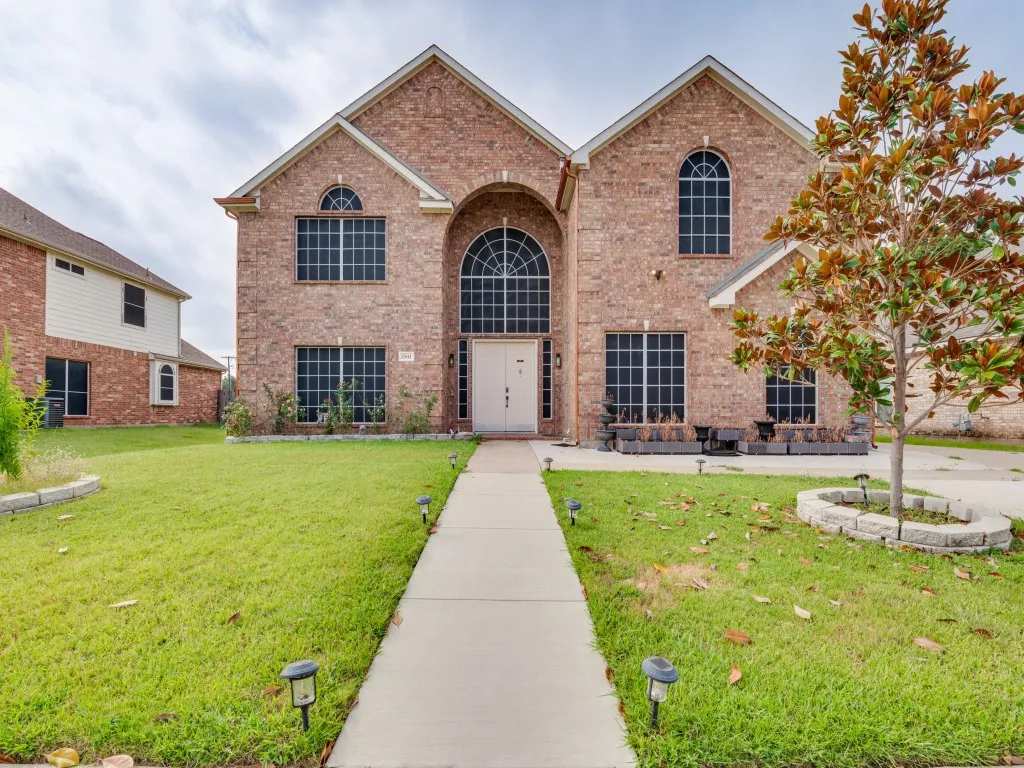Brick exterior featuring multiple arched windows and a prominent entryway