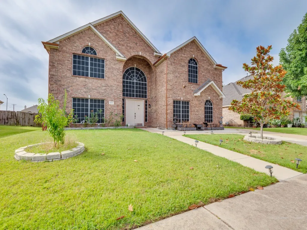 Two-story brick exterior featuring multiple arched windows and a prominent arched entry