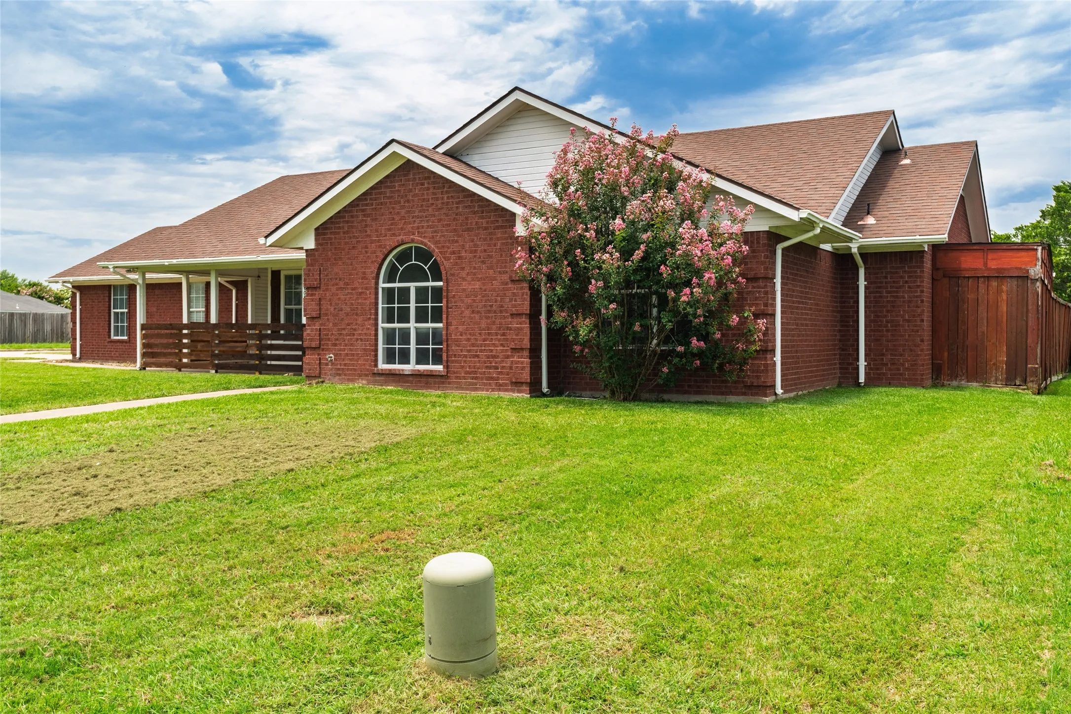 Red brick exterior with a brown shingle roof