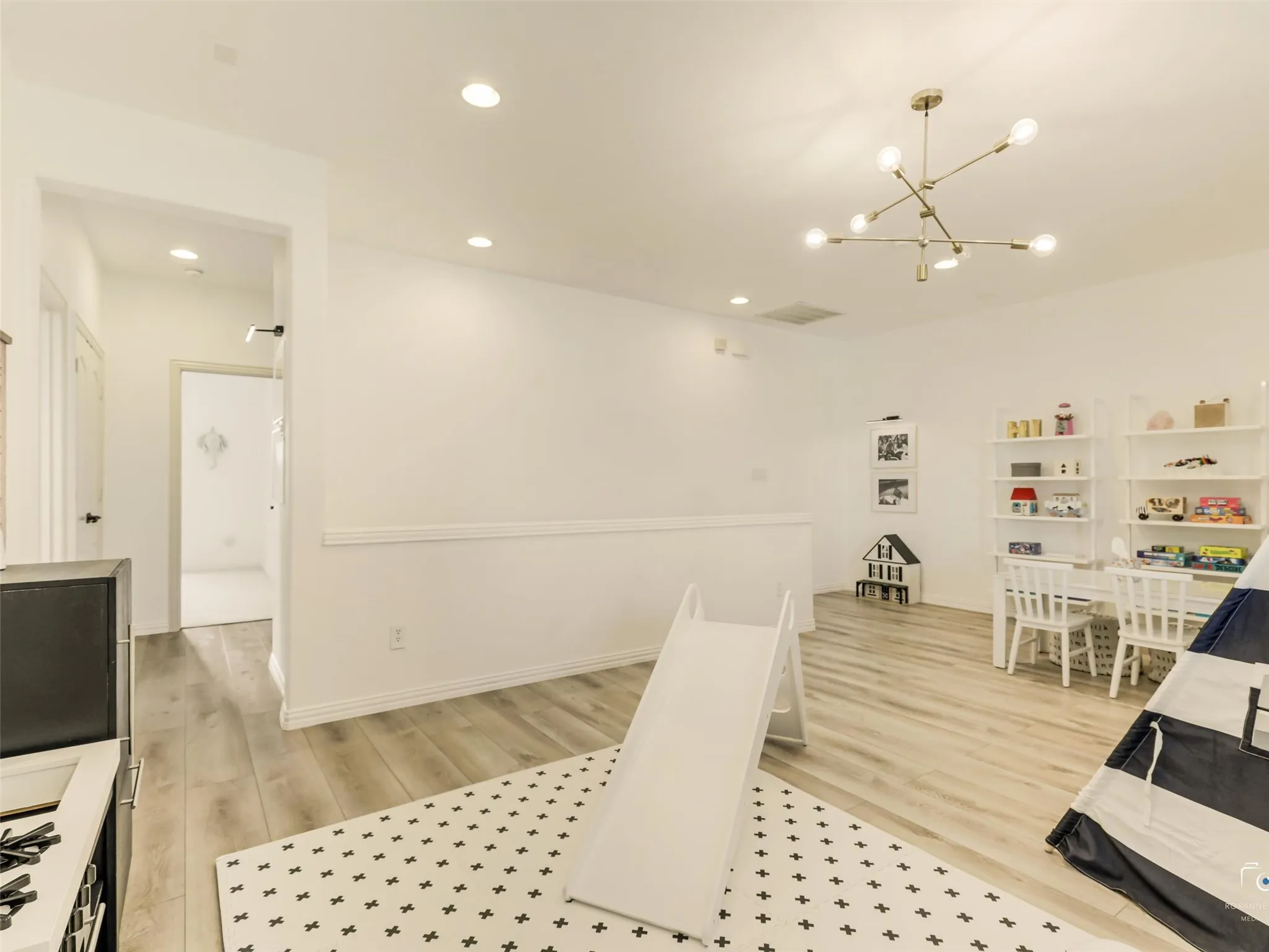 Spacious upstairs game room offers endless possibilities as a playroom, media lounge, home office, or second living area with room for everyone to gather.