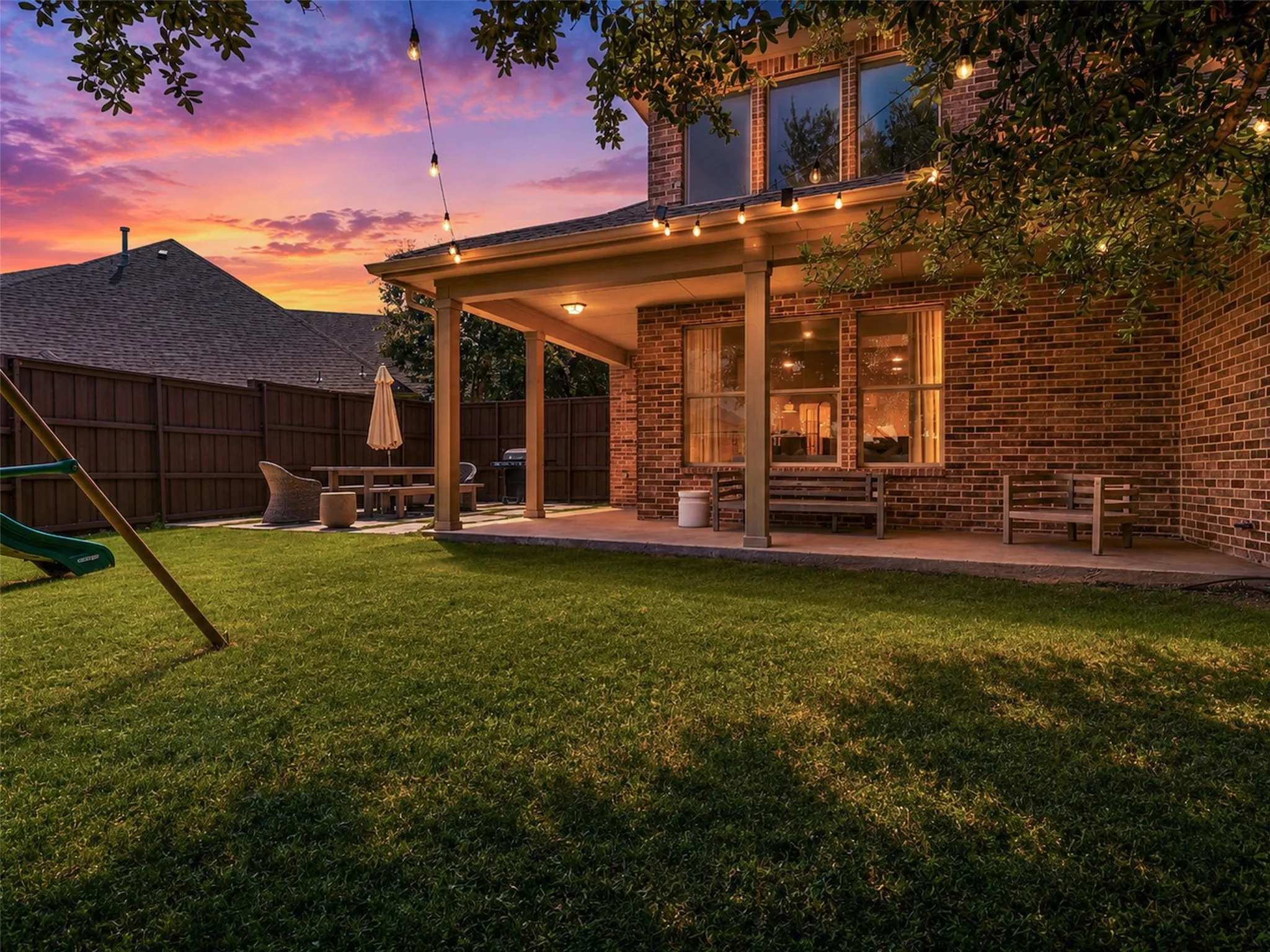 Private backyard featuring a covered patio, extended entertaining space, and plenty of room to relax, play, or host guests.