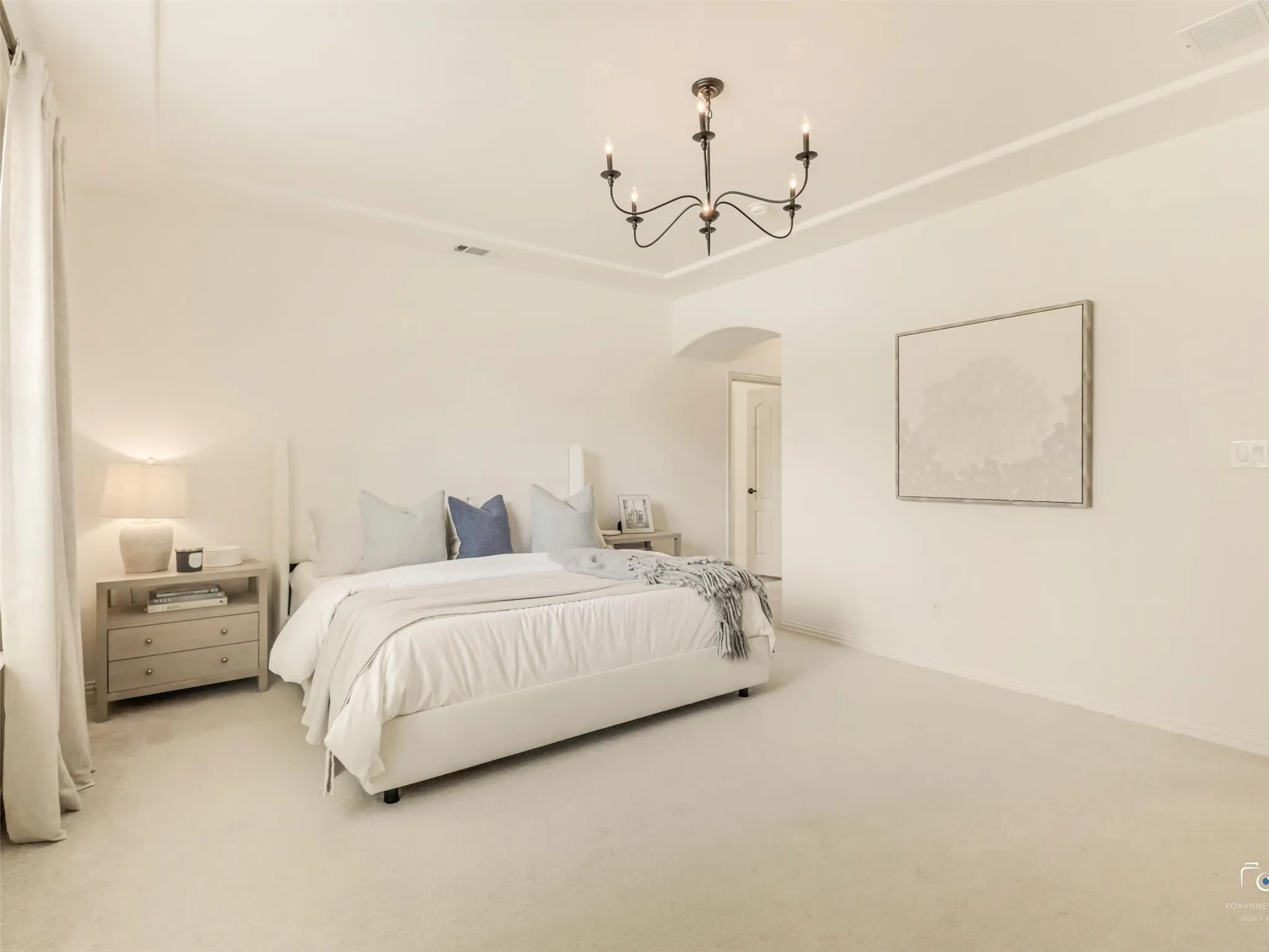 Spacious secondary bedroom showcases oversized windows, designer lighting, and plenty of room to personalize for any lifestyle.
