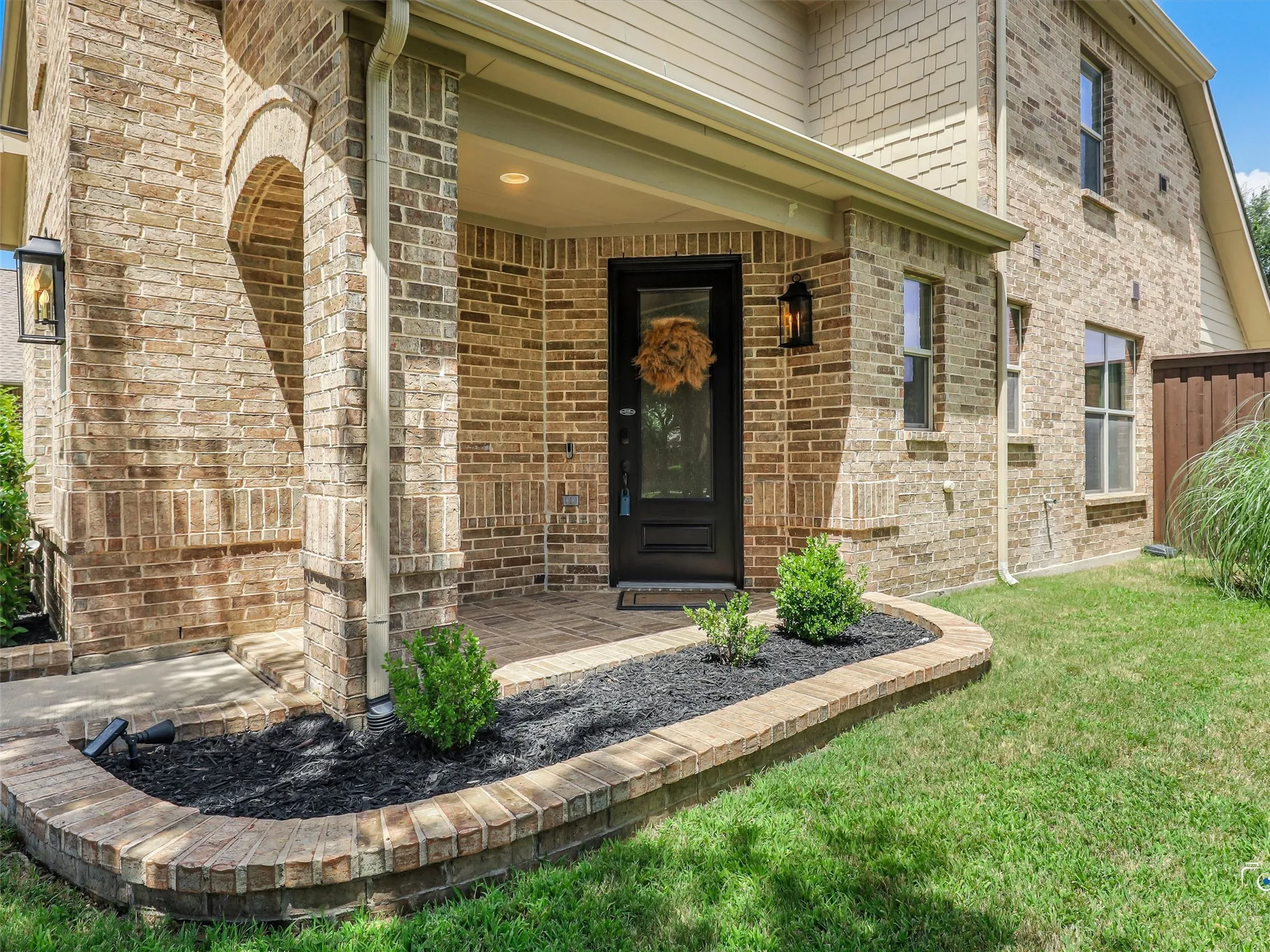 Covered front porch with updated glass front door creates a warm and inviting first impression, and also brings in natural light inside home.