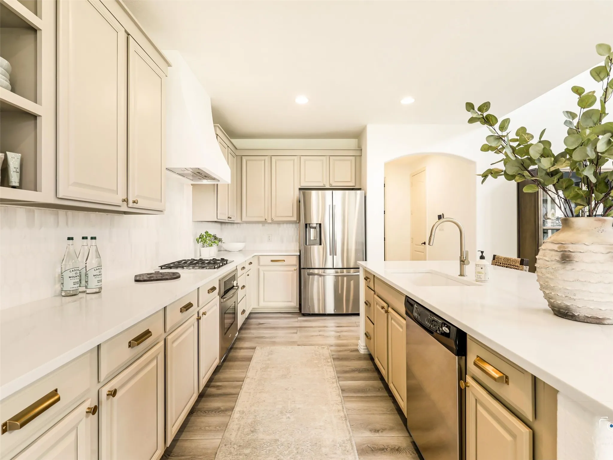 Open-concept living at its finest with soaring ceilings, abundant natural light, and seamless flow into the chef-inspired kitchen. The oversized island with seating creates the perfect gathering space for everyday living and entertaining.