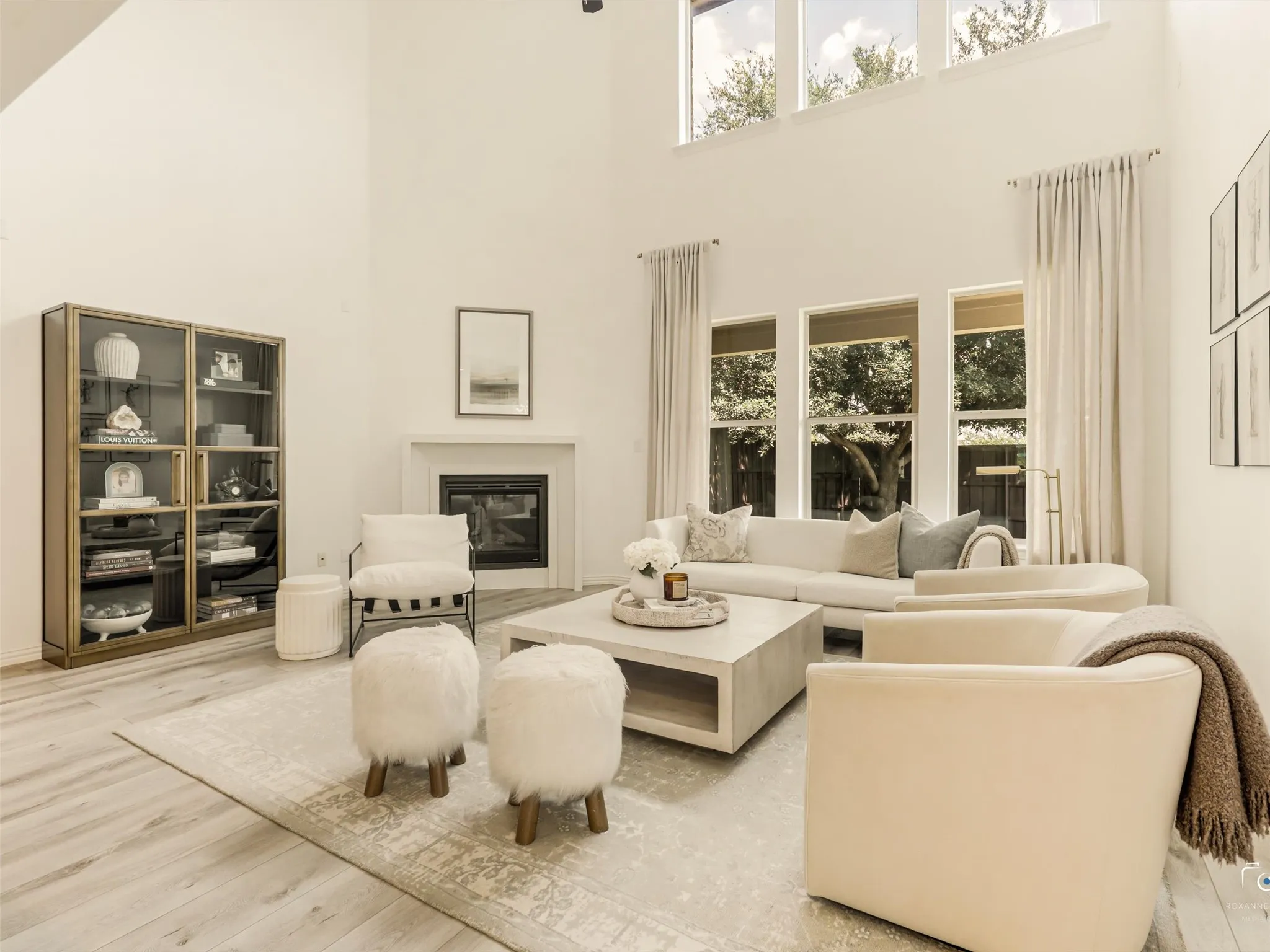 Impressive two-story living room with updated fireplace creates a stunning focal point for gatherings.